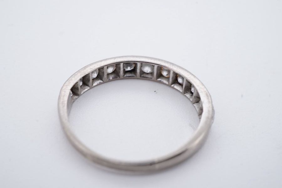 A diamond half eternity ring, set to the front with a sequence of brilliant-cut diamonds totalling approximately 0.80 carats, mounted in white gold, size O1/2, stamped 18CT, gross weight approximately 2.5 grams